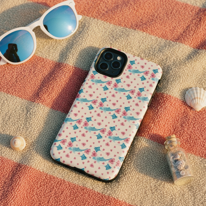 Phone case with a floral pattern on a textured surface with sunglasses and shells.