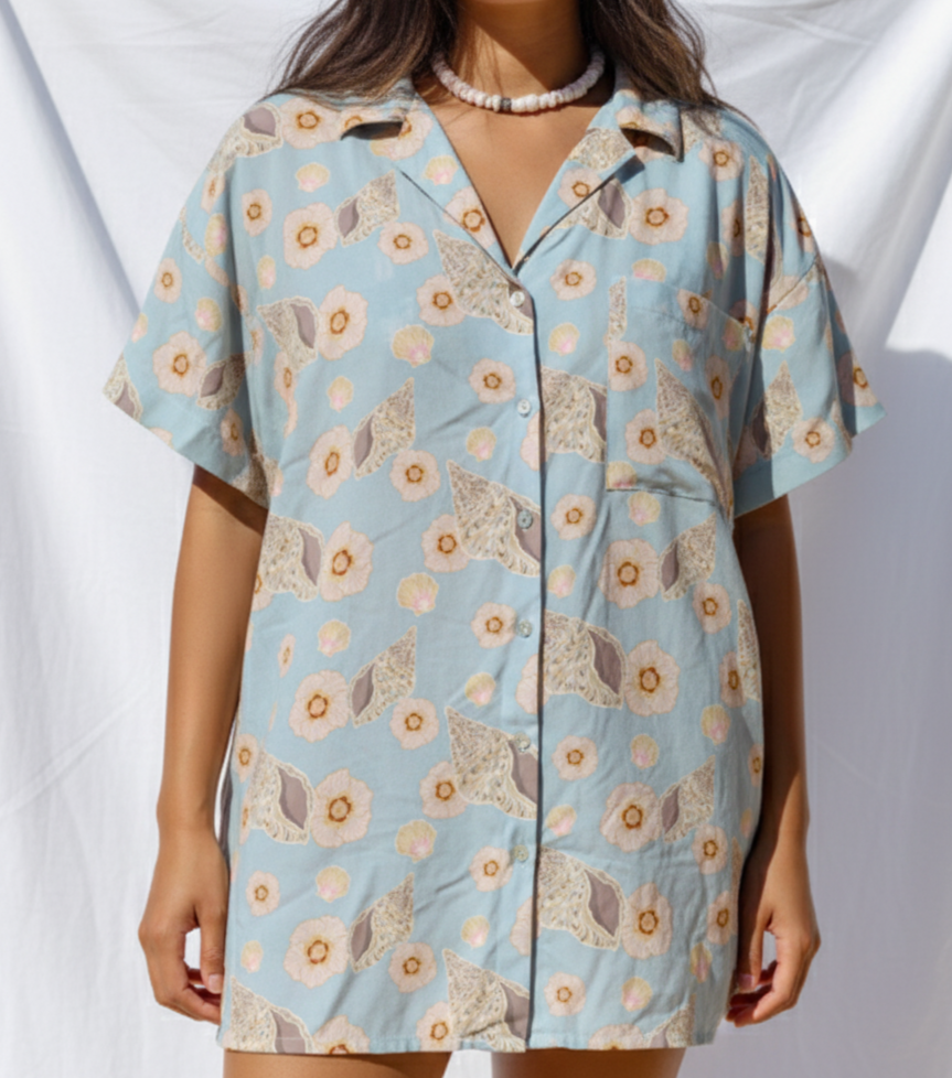 Woman wearing a floral patterned dress against a white background
