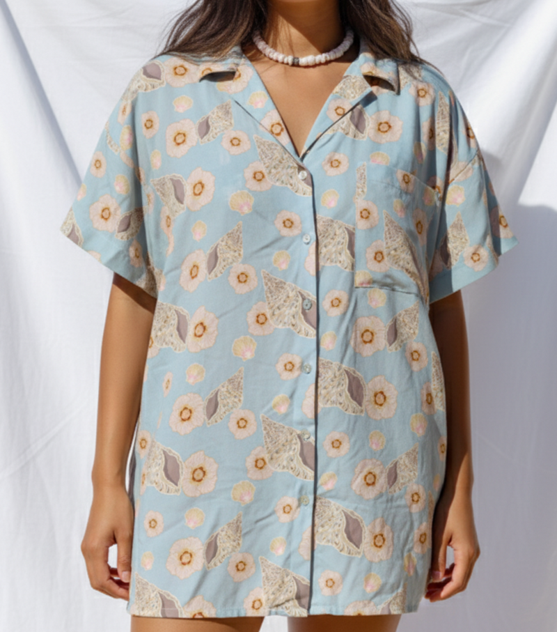 Woman wearing a floral patterned dress against a white background