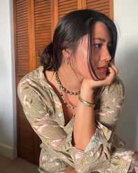 Woman wearing a floral dress with a neutral background